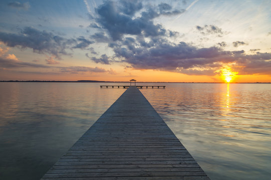 wooden pier overlooking the lake, the beautiful evening sky, colored by the setting sun © Mike Mareen