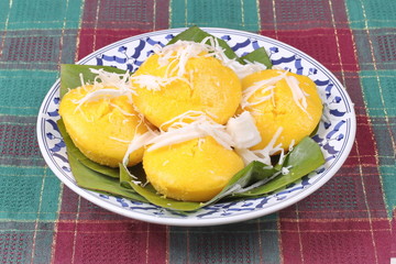Toddy palm cake topped roll coconut .