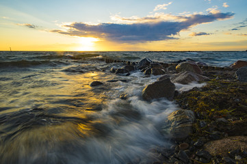 sea landscape, waves breaking on the breakwater pile of wood, baltic sea

