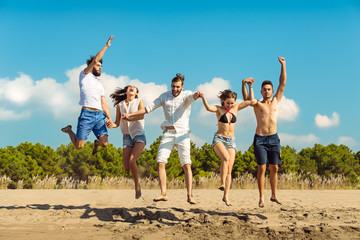 Group of friends together on the beach having fun.