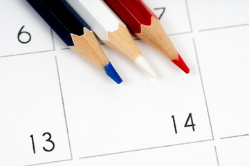 red white blue pencils on empty calendar grid