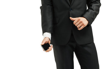 close-up of torso  man in suit and tie  modern smartphone in hand. on the left side  the photo is blank for your text