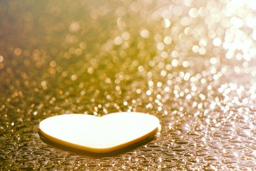 the heart shape wood on the rain drops and the sunlights