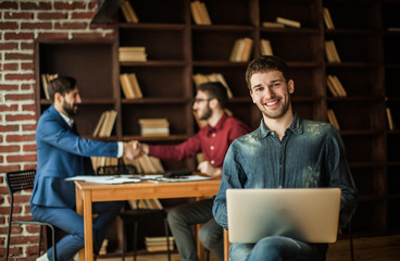 sales Manager with notebook on background of business partners h