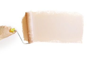 Hand holding a paint roller with  gray, drawn strip of   for advertising copy