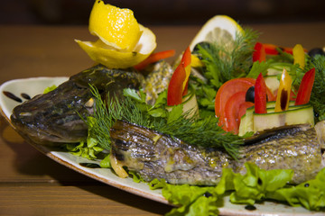 Stuffed pike with vegetables and herbs.