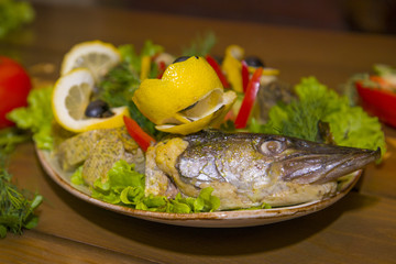 Stuffed pike with vegetables and herbs.
