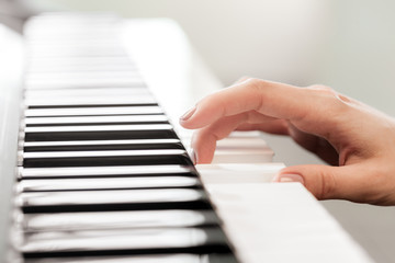 Fototapeta na wymiar Closeup of hands playing piano. Music and hobby concept