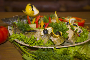 Stuffed pike with vegetables and herbs.