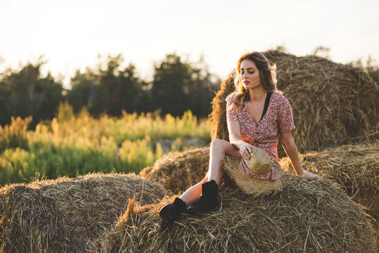 Beautiful woman on a haystack