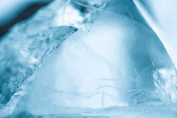 Frozen blue ice blocks with bubbles of air macro close-up