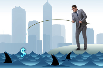 Businessman fishing out dollars from water