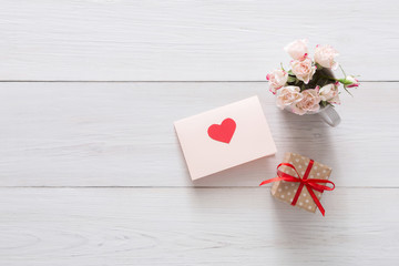 Valentine day background, heart and flowers on white wood