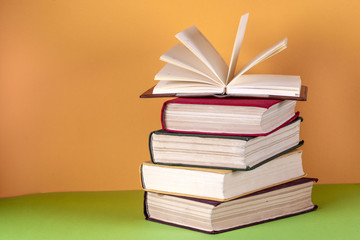 Open book, hardback bookson bright colorful background.