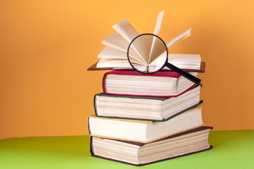 Open book, hardback bookson bright colorful background.