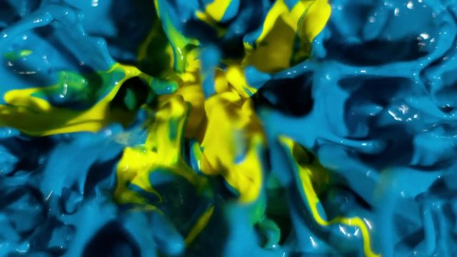A circle of yellow surrounded by bright blue dances in slow motion