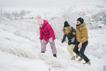 family climbs the hill and having fun