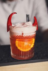 Creative spicy cocktail in night club bar background