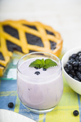 Piece of a blueberry pie and smoothies .