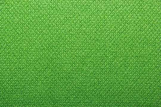 Knitted texture. Green wool. Knitted green background of natural wool.