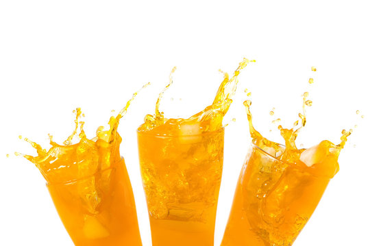 Orange juice splashing out of glass., Isolated white background with copy space.