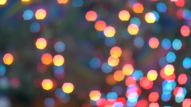 Multi-colored lights flashing lights on a dark background.
