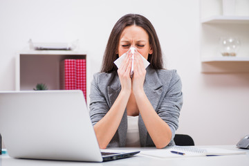 Young businesswoman is having allergy problem. 