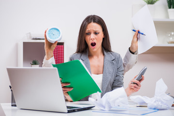 Young businesswoman is angry because she has too much work.