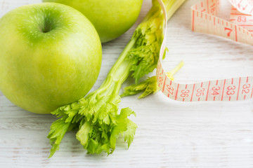 green apples, celery and tape measure
