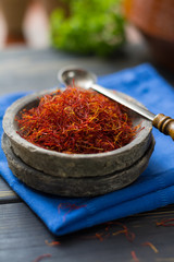 Raw Organic Red Saffron Spice in a clay bowl