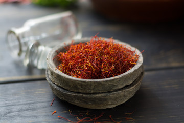 Raw Organic Red Saffron Spice in a clay bowl