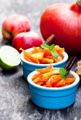 Caramelized  pumpkin and apple in small pot on wooden table