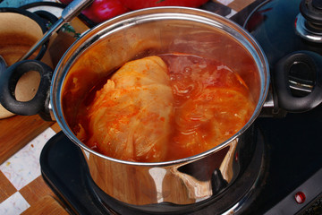 Stuffed cabbage rolls cooking in a pot