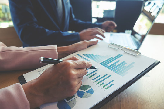 Business concept. Business people discussing the charts and graphs showing the results of their successful teamwork.