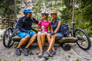 Family bike rides in the mountains while relaxing on the bench.