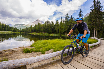 Fototapeta premium Mountain biking in the Dolomites, Misurina, Italy. Tre Cime di L