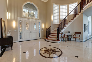 Stunning two story entry foyer with marble mosaic tiled floor