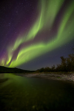 Aurora Borealis over the river. River Paypudyna. Polar Urals. Russia.