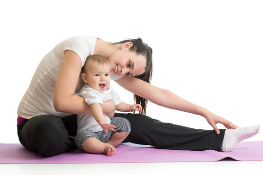 Young woman mother doing fitness exercises with baby, studio portrait isolated on white background