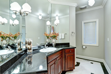 Soft grey bathroom interior boasts mosaic marble floor