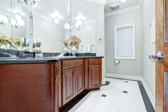 Soft grey bathroom interior boasts mosaic marble floor