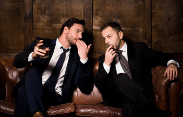 Collusion in business and global conspiracy between two successful businessmen. Rich men spending...