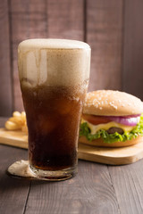 BBQ hamburgers with cola on wooden background