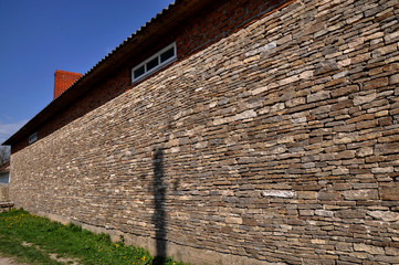 Fototapeta na wymiar Wall from natural river stone used for construction of housing and commercial buildings