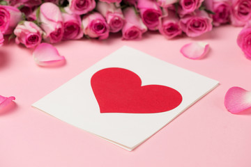 Valentine's Day greeting card with rose flowers over pink backgr