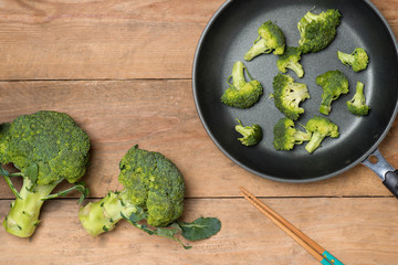 Top view of Fresh green broccoli on rustic wooden background - h