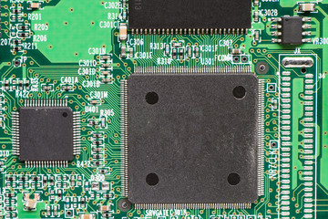 Close up of printed electronic circuit board with microcontroller and components;