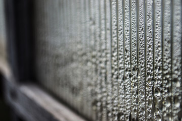 Drop of  close on a plastic wrap - light abstract natural water background