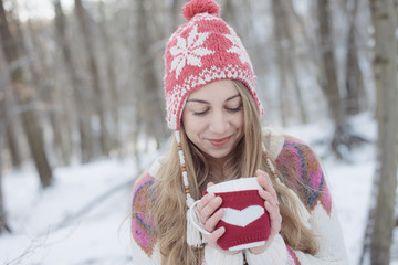 Beautiful Girl Drinking Tea or Coffee outdoor. Woman with a cup of Hot Beverage.	