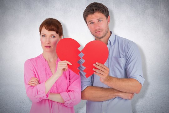 Composite image of couple holding a broken heart